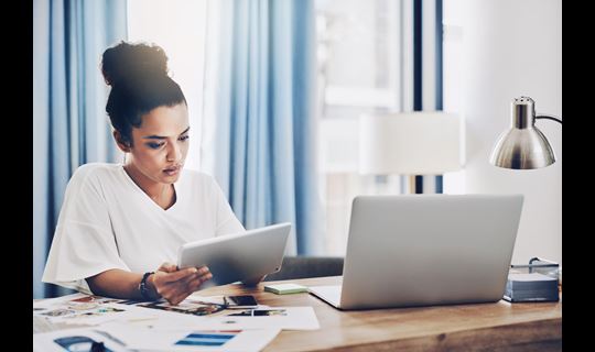 Female with tablet and laptop