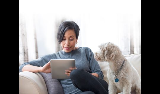 Woman with tablet and dog